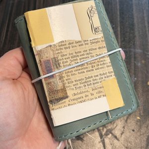 A finished mini junk journal on top of a pocket TN