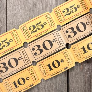 Three rows of vintage yellow carnival tickets
