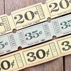Three rows of light green vintage carnival tickets