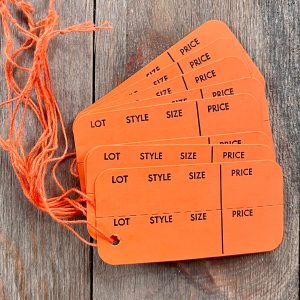 Eight vintage strung orange clothing tags