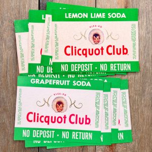 Eight green, white, and red vintage Clicquot Club soda labels featuring an Eskimo child’s head