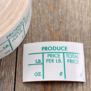 A vintage green and white Produce price label sticker, next to the roll it came from