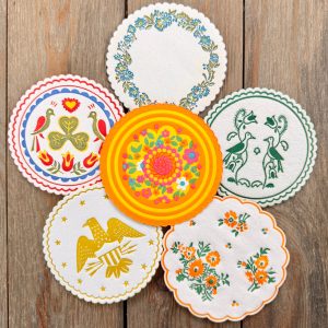 Six different vintage paper coasters with vibrant designs