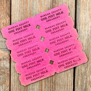 A sheet of a vintage pink dairy coupons for one pint of milk