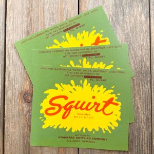3 Vintage green, yellow, and red Squirt soda labels