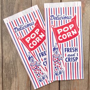 2 Vintage red, white, and blue paper popcorn bags that say Delicious Popcorn Fresh and Crisp and features a circus clown