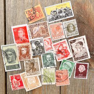 20 different vintage and antique postage stamps in various colors - orange, yellow, green, and brown