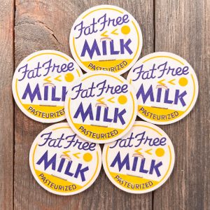 6 Vintage white, blue, and yellow Fat Free Milk caps in a mid-century style