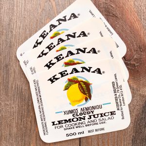 4 Vintage white Keana Cloudy Lemon Juice Labels with a yellow lemon illustration and bold black text
