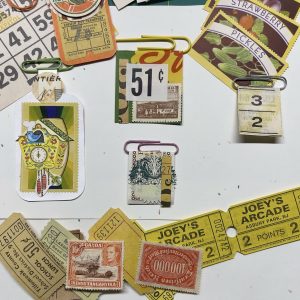 Altered paper clips, collaged with vintage ephemera