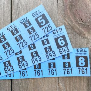 Three strips of vintage sky blue dry cleaning tickets
